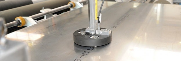 Eddy current probe integrated into an automated aluminum plate inspection system