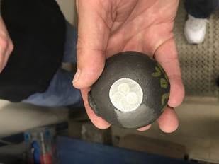 A ball before (left) and after (right) being used in a grinding mill.