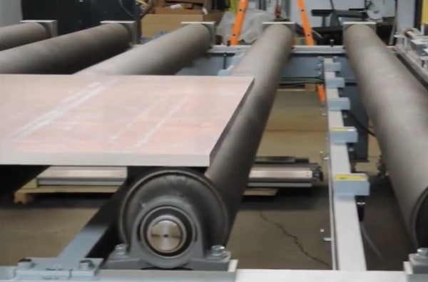 Aluminum plate on rollers in a metallurgical manufacturing plant