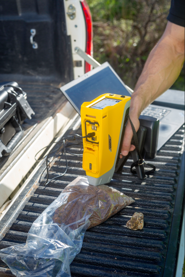 A hand holding a yellow and grey device AI-generated content may be incorrect.