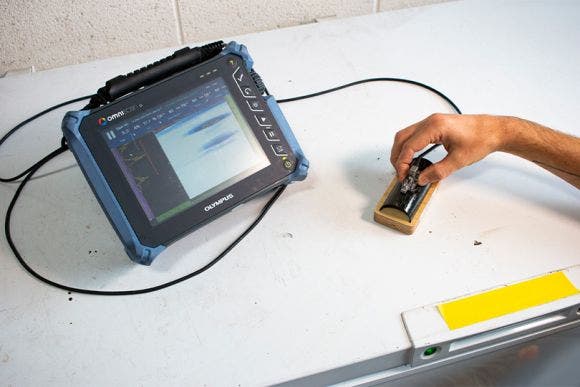 OmniScan SX flaw detector and phased array probe on a composite tube specimen