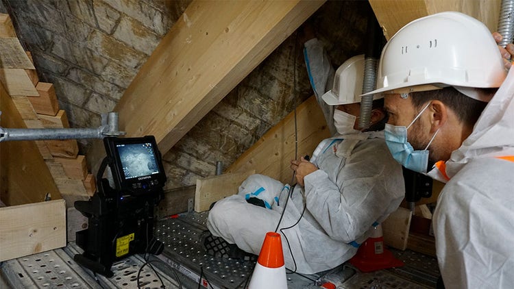 Trabajadores de restauración usando equipos de protección individual (EPI) en una inspección boroscópica asociada al estado de las bóvedas de la Catedral de Notre Dame de París tras el incendio