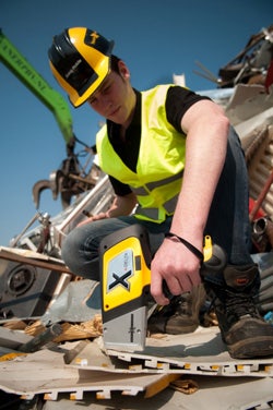 Inspector testing scrap metal wtih Delta Handheld XRF for Alloys