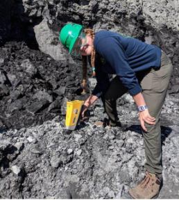 Scientist using an XRF gun to test coal mine deposits