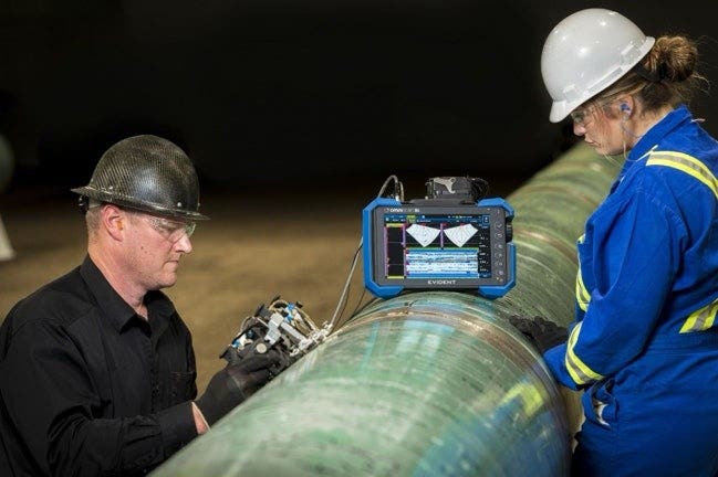 Men wearing hardhats looking at a machine AI-generated content may be incorrect.
