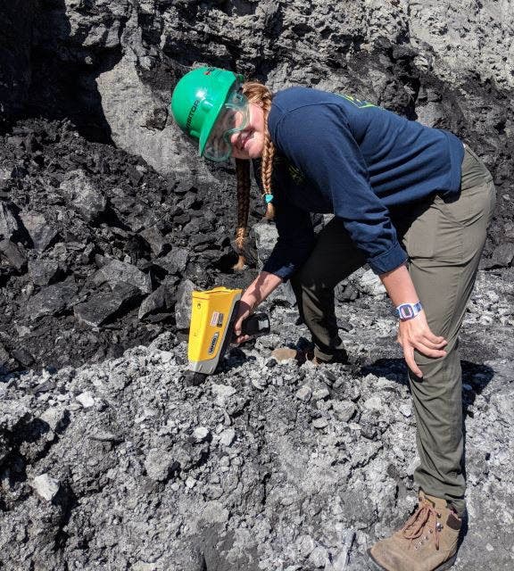 Scientist using an XRF gun to test coal mine deposits