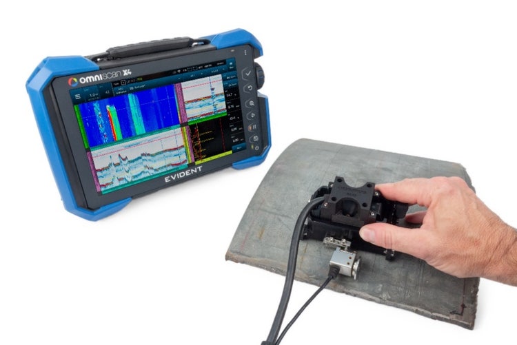 A hand holding a device Description automatically generated