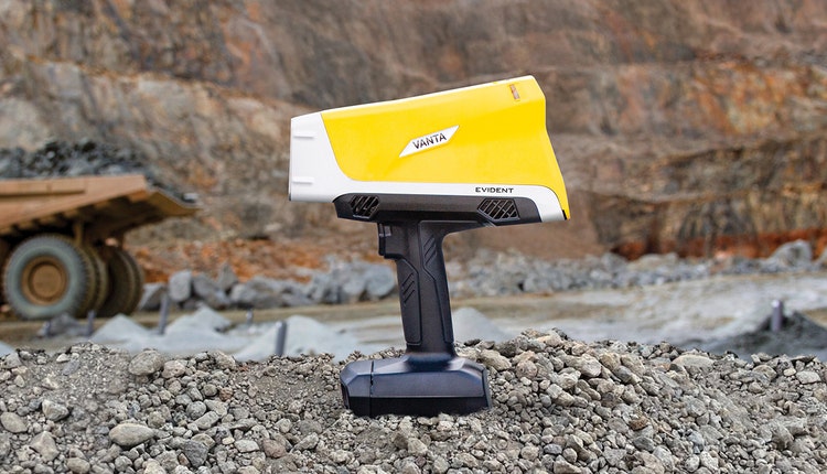 A yellow and white device on rocks Description automatically generated
